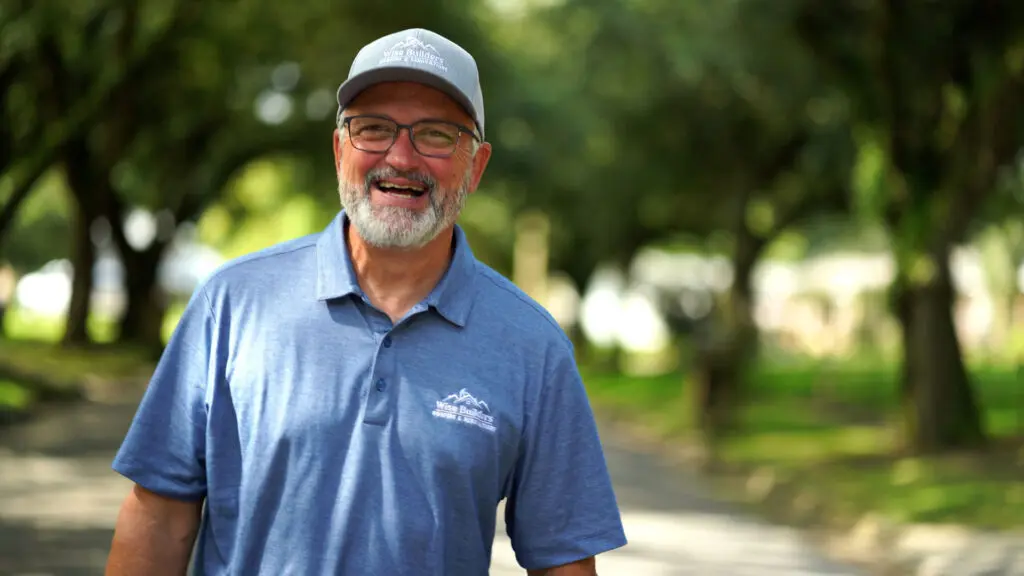 a happy wise builder project manager ready to assist customers in mobile al