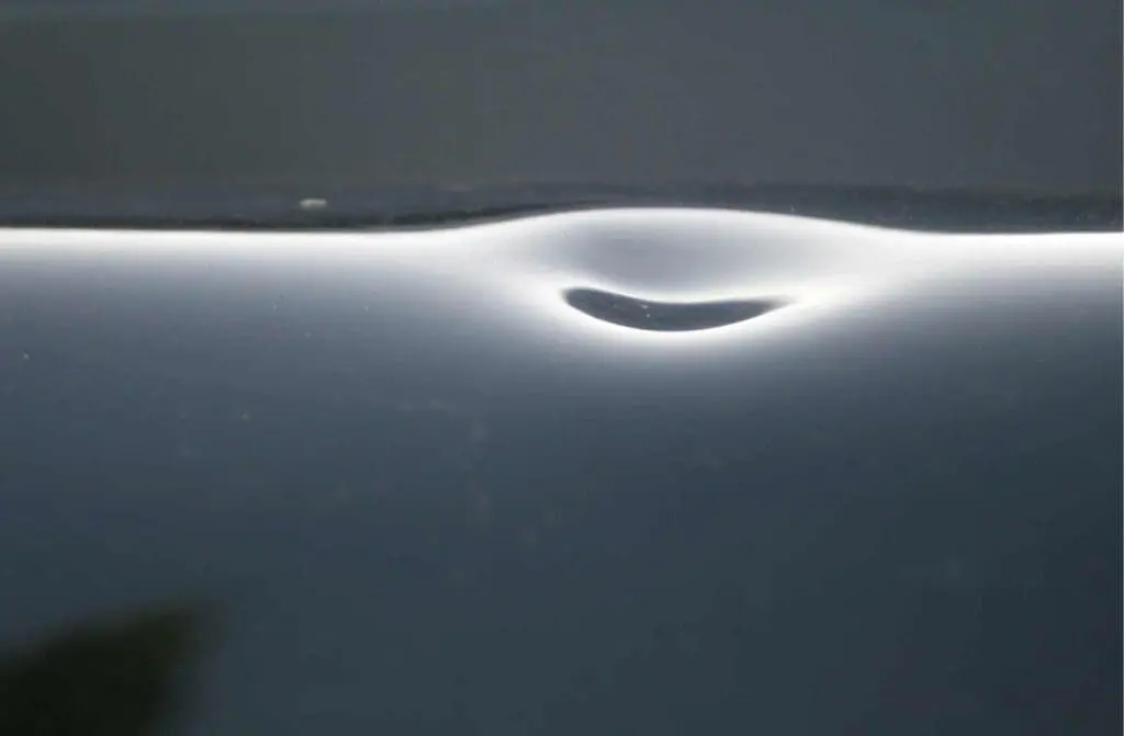 dent on a metal roof