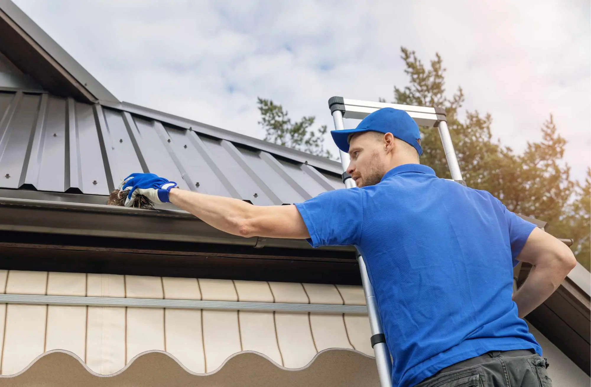 a project manager cleaning a gutter system