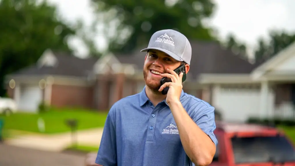 a professional metal roofing expert on the phone with a customer that needs a little maintenance