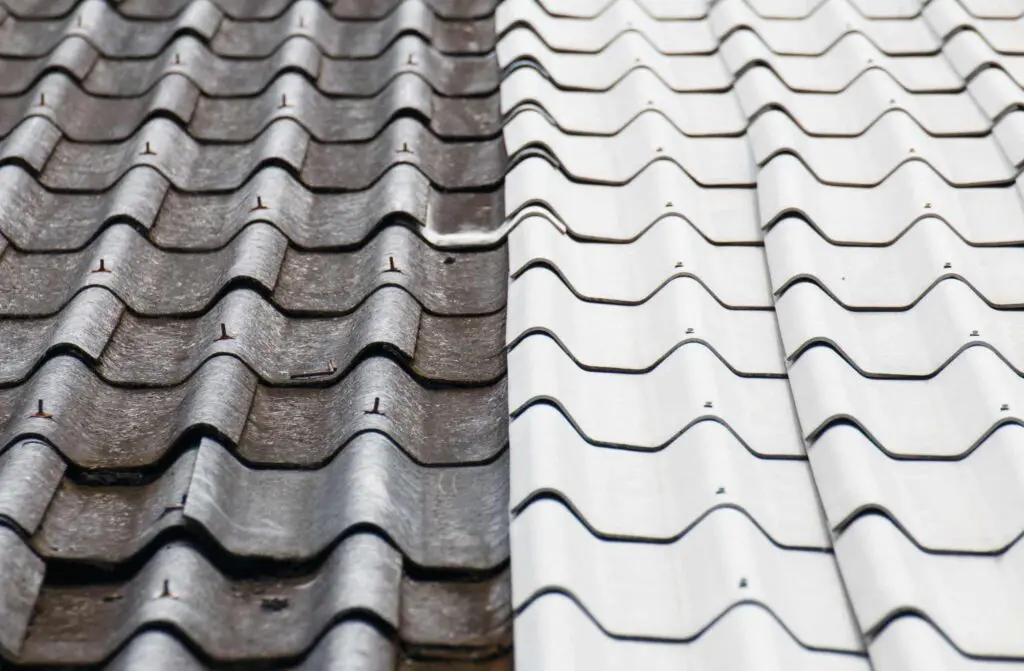 a metal roof that has been exposed to extreme weather and half has been cleaned