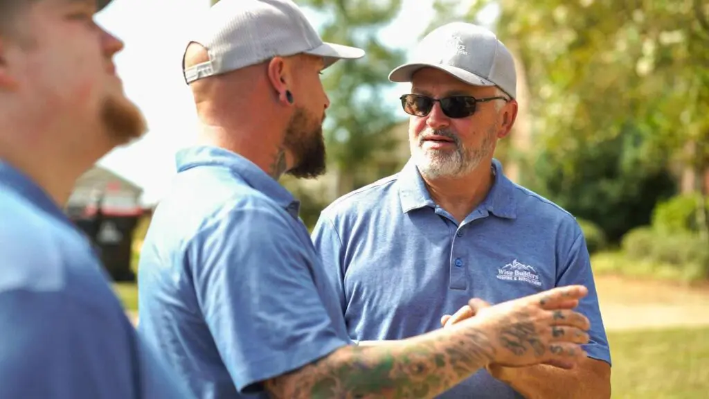 project managers from wise builders roofing and renovations talking about standing seam metal roofing