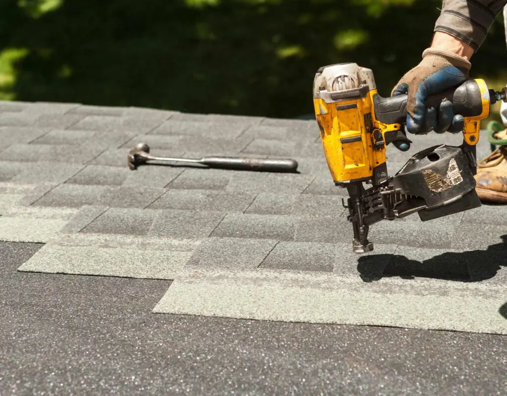 a roofer installing a new asphalt shingle roof system