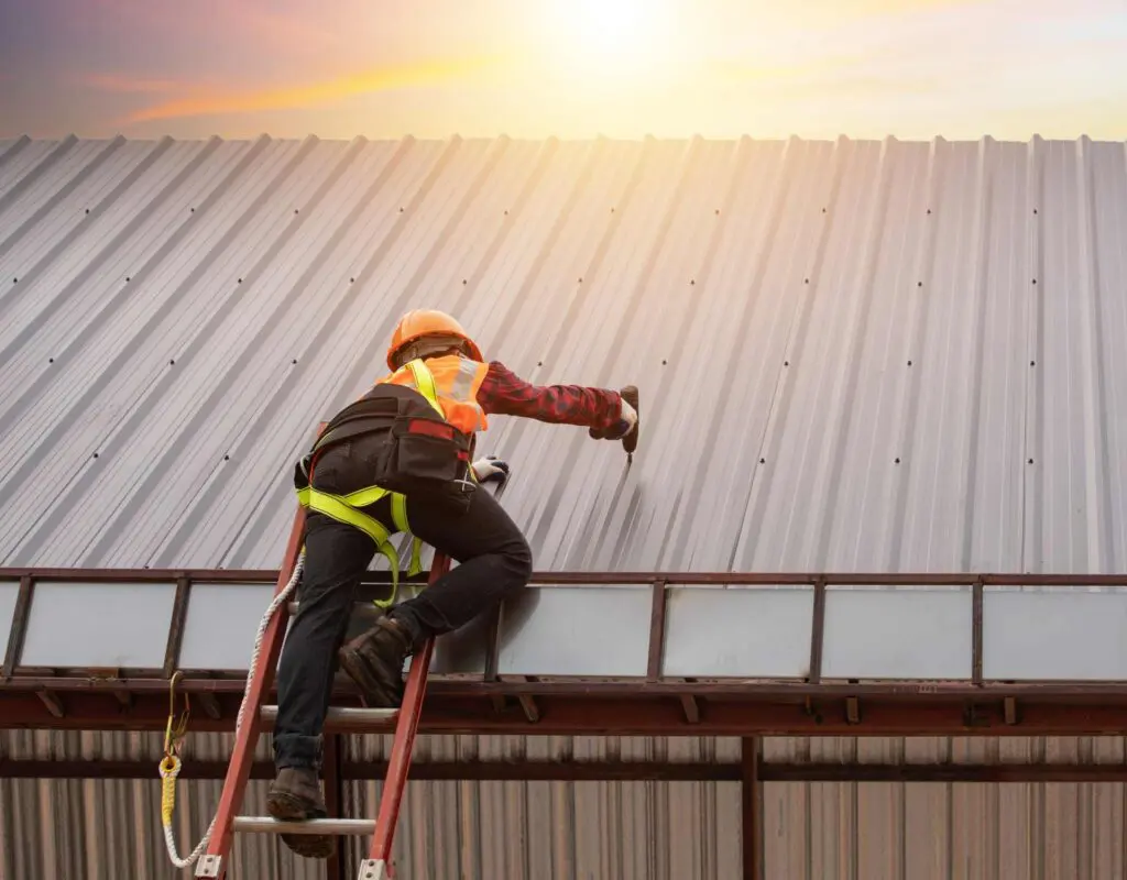 a worker working on a steel roof which is a type of metal roofing