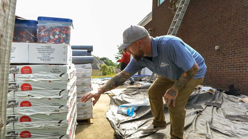 a roofer inspecting asphalt shingles