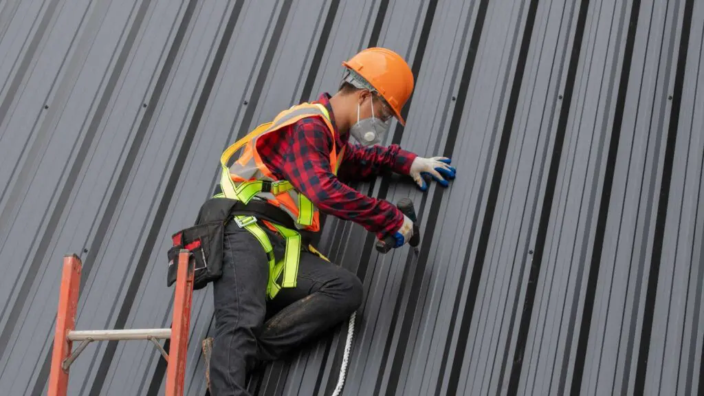 right roofing contractor working on a metal roof