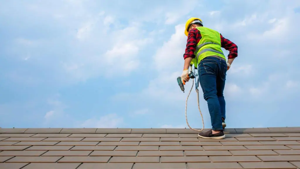a working on the rooftop built with shingles
