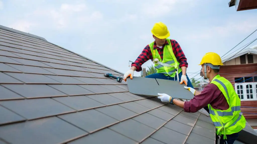 two roofers working on a roof