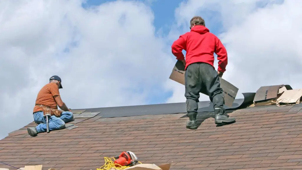 a roofing contractor working on a roof job making sure it is done right