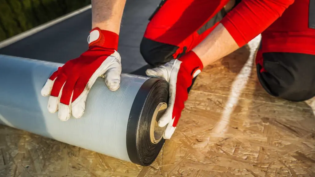 rolled roofing being installed