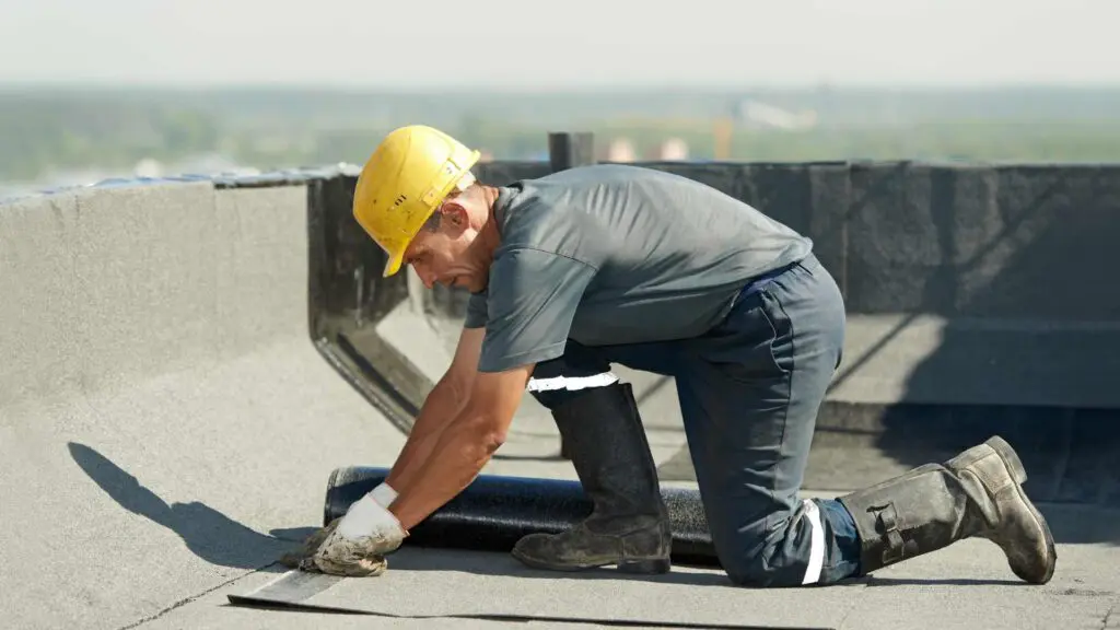 a roofing contractor working on a commercial roof