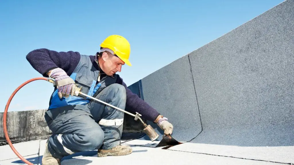 a roofer working on a commercial roofing project