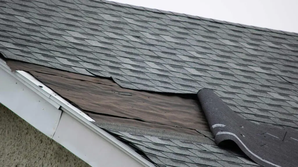 an asphalt shingle roof with wind damage