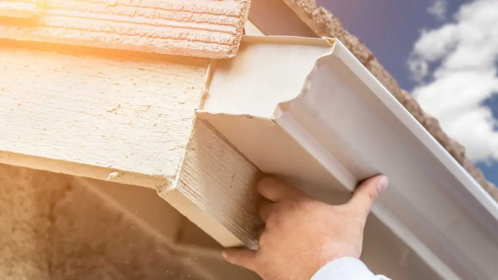 gutters being installed on cedar fascia