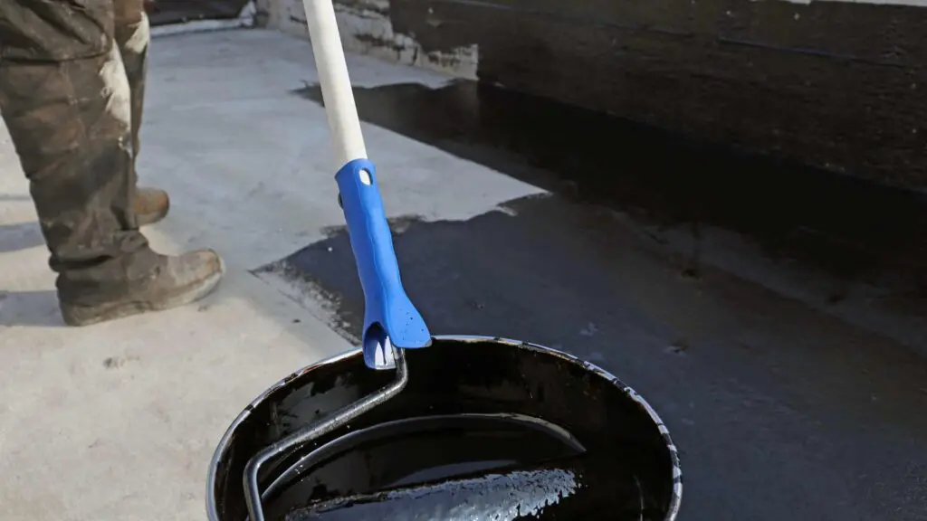 a roller being put into roof paint