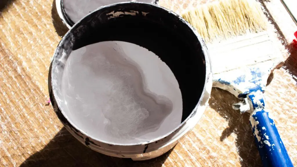 roof paint and a paintbrush