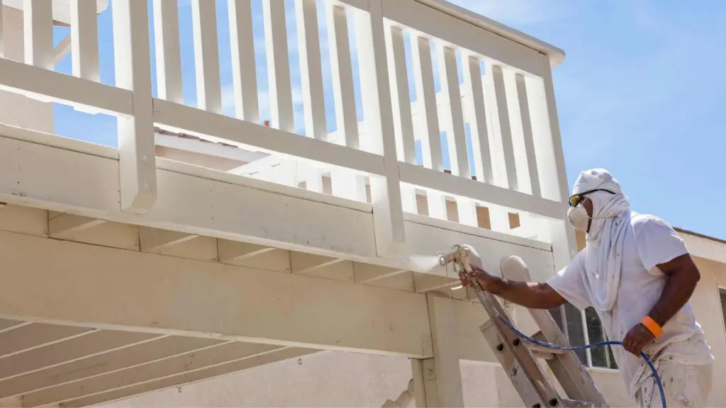 using a spray gun to paint decking