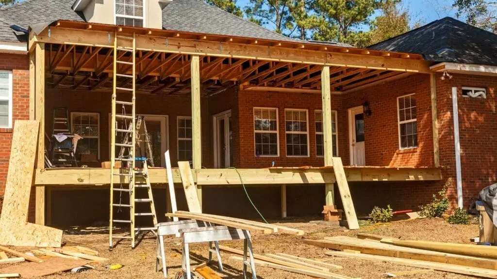 a roof deck being installed on the outside of a home
