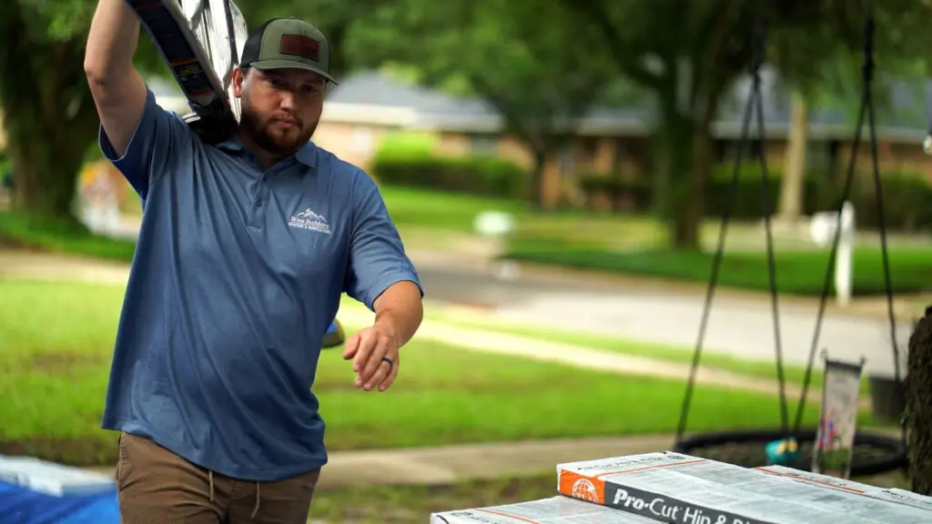 a roofer from wise builders preparing to inspect a metal roof for dents from hail
