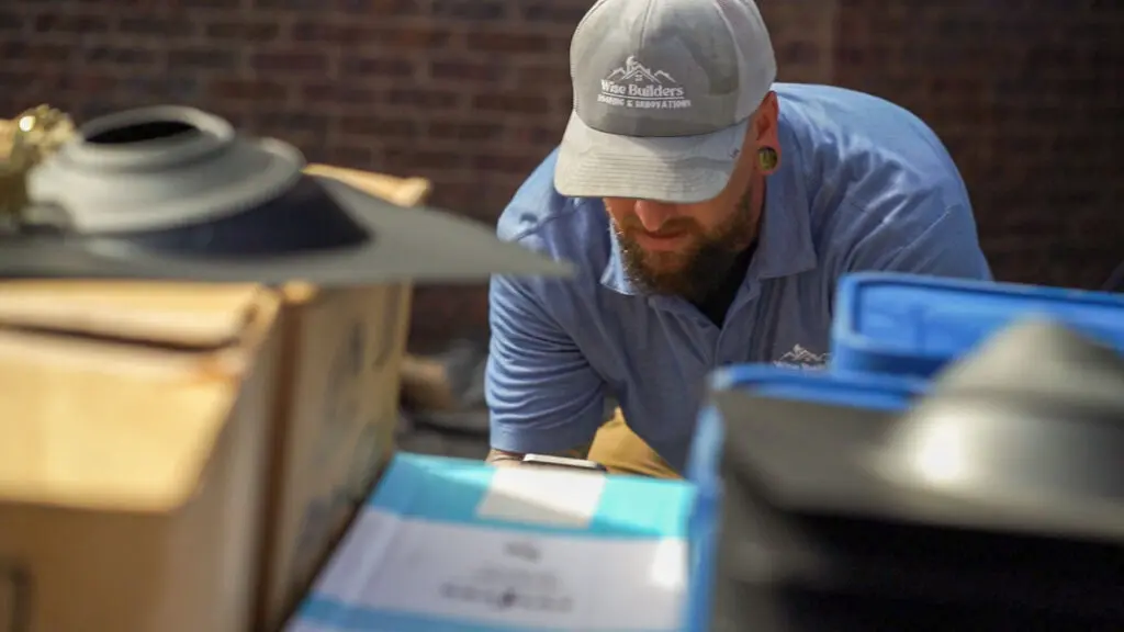 a project manager from wise builders inspecting commercial building roofing supplies
