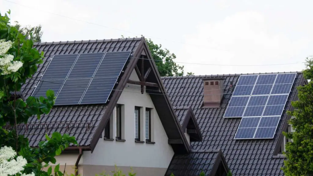two metal roofs with solar panels on them