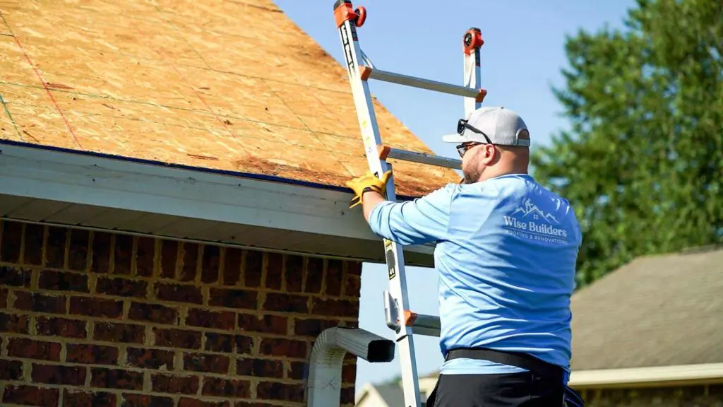 a project manager from the roofing company Wise Builders climbing a ladder to inspect a new roof install