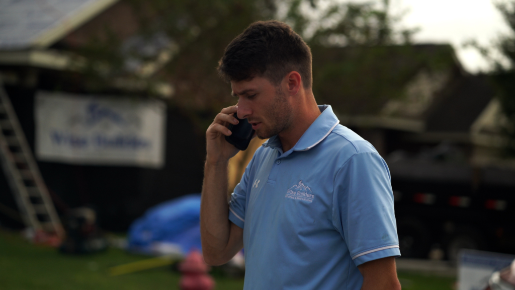 a roofer on the phone with a new roof customer in mobile al