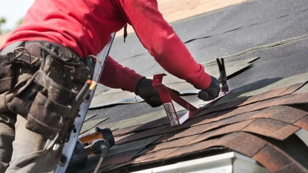 a roofer working to repair a asphalt shingle roof