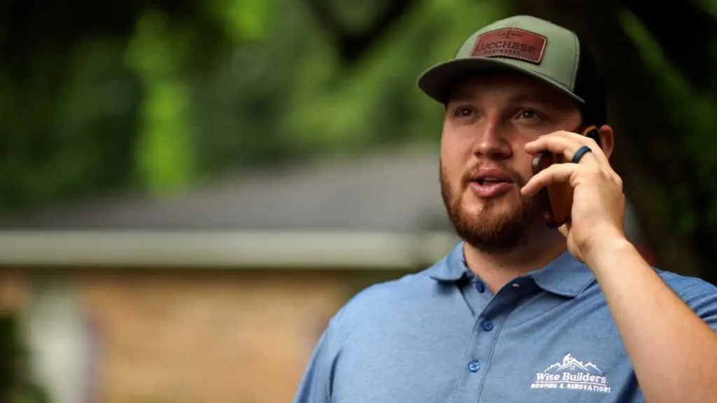 a project manager from wise builders roofing and renovations on the phone with a preventative maintenance customer