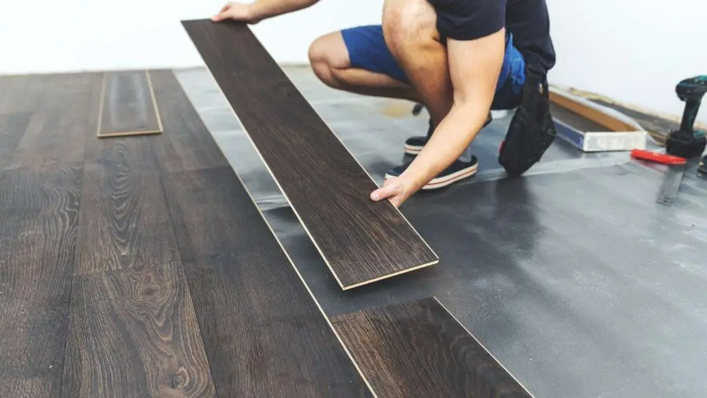 a worker installing LPP flooring by wise builders roofing and renovations in mobile Alabama