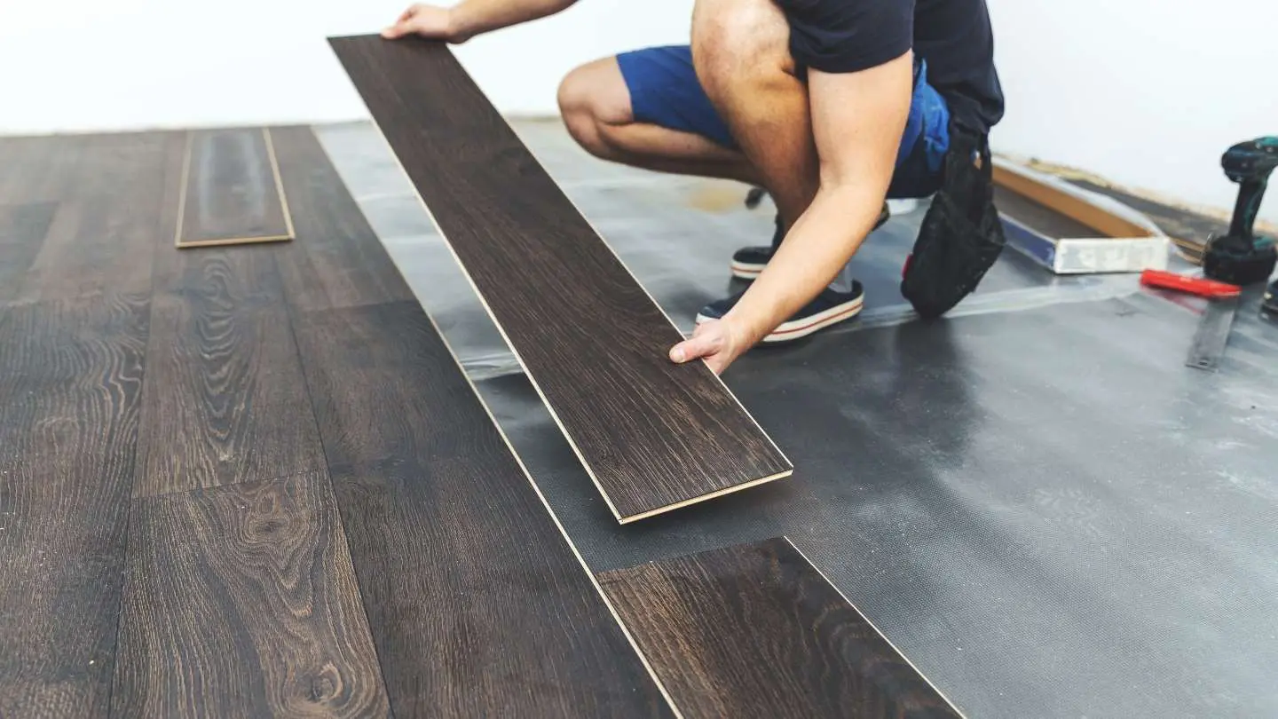 A Wise Builders crew member installing new flooring during an accessibility remodel in Mobile, Alabama