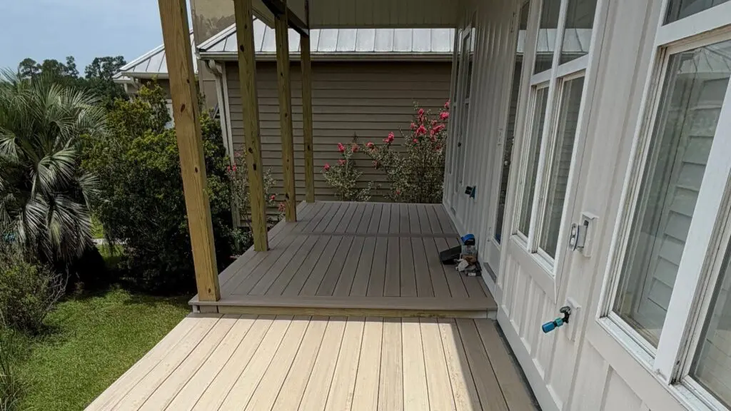 New covered porch with composite decking and exterior trim on a Baldwin County home by Wise Builders