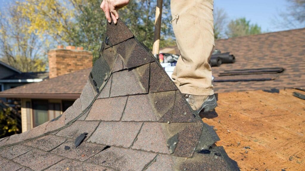 a roofer repairing a leaking roof