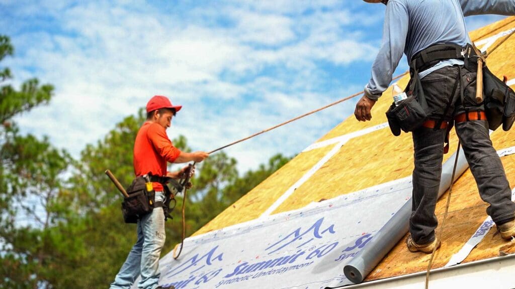 two roofers installing a new roof in alabama