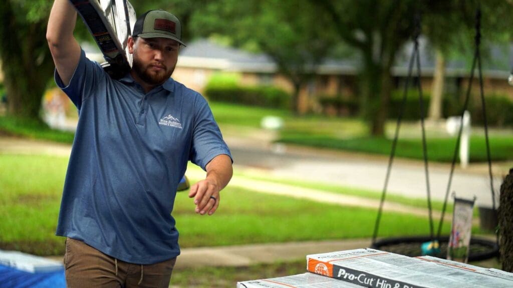 a commercial roof expert carrying a ladder