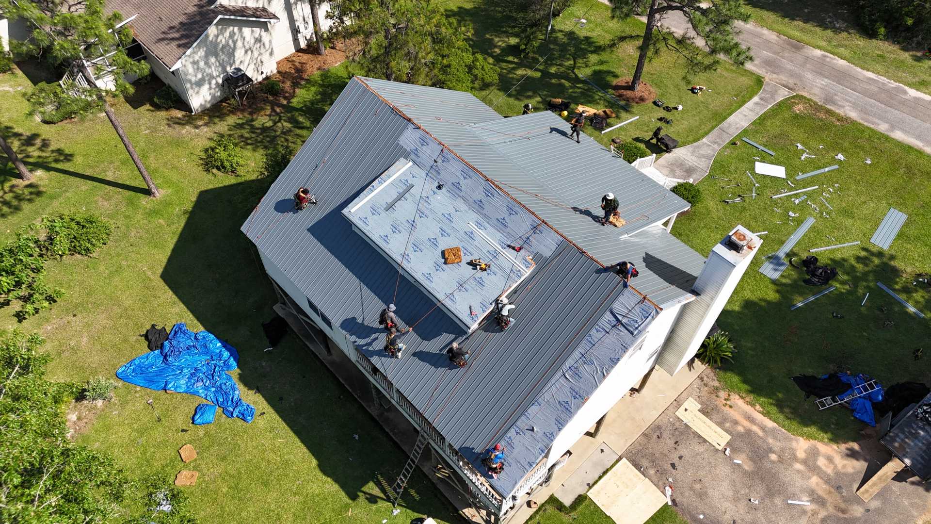 roofers from wise builders roofing and renovations installing a new metal roof