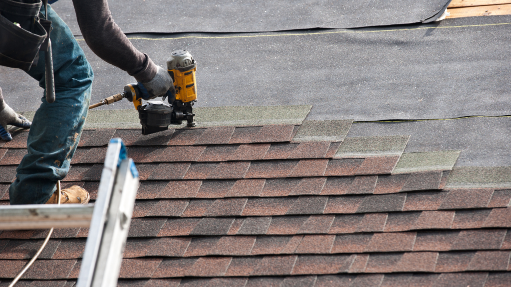 Roofer installing new shingles